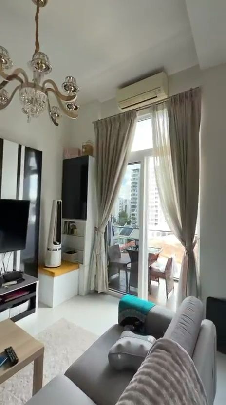 The living room with the city visible through full-height glazing
